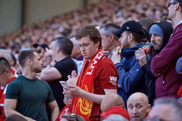 LIVERPOOL, ENGLAND - Sunday, May 12, 2019: Liverpool supporters check the score of the Brighton & Hove Albion versus Manchester City match on their smart phones during the final FA Premier League match of the season between Liverpool FC and Wolverhampton Wanderers FC at Anfield. (Pic by David Rawcliffe/Propaganda)