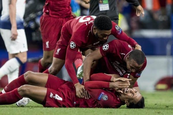 MADRID, SPAIN - SATURDAY, JUNE 1, 2019: Liverpool's Virgil van Dijk collapses to the pitch at the final whistle as team-mates Joel Matip and Joe Gomez embrace him as they celebrate a 2-0 victory in the UEFA Champions League Final match between Tottenham Hotspur FC and Liverpool FC at the Estadio Metropolitano. (Pic by Paul Greenwood/Propaganda)