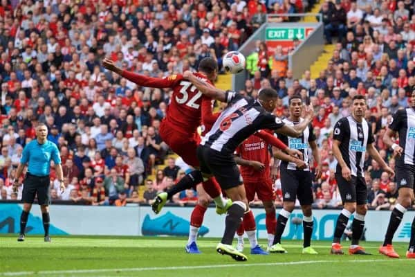 LIVERPOOL, ENGLAND - Saturday, September 14, 2019: Liverpool's Joel Matip is pulled back by Newcastle United's captain Jamaal Lascelles put no penalty is awarded during the FA Premier League match between Liverpool FC and Newcastle United FC at Anfield. (Pic by David Rawcliffe/Propaganda)