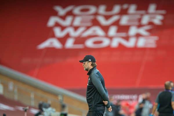 LIVERPOOL, ENGLAND - Wednesday, June 24, 2020: Liverpool’s manager Jürgen Klopp in front of a banner "You'll Never Walk Alone" before the FA Premier League match between Liverpool FC and Crystal Palace FC at Anfield. The game was played behind closed doors due to the UK government’s social distancing laws during the Coronavirus COVID-19 Pandemic. (Pic by David Rawcliffe/Propaganda)