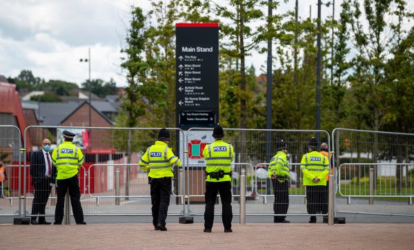 LIVERPOOL, ENGLAND - Saturday, July 11, 2020: Police officers stand outside the Anfield, part of an unusually large police presence for a game without any supporters, pictured before the FA Premier League match between Liverpool FC and Burnley FC at Anfield. The game was played behind closed doors due to the UK government’s social distancing laws during the Coronavirus COVID-19 Pandemic. (Pic by Propaganda)