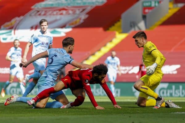 LIVERPOOL, ENGLAND - Saturday, July 11, 2020: Liverpool’s Mohamed Salah is held back by Burnley's James Tarkowski but no penalty was awarded during the FA Premier League match between Liverpool FC and Burnley FC at Anfield. The game was played behind closed doors due to the UK government’s social distancing laws during the Coronavirus COVID-19 Pandemic. (Pic by Propaganda)