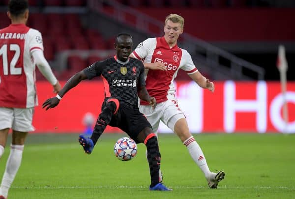 AMSTERDAM, THE NETHERLANDS - Wednesday, October 21, 2020: Liverpool's Sadio Mané (L) and Ajax's Perr Schuurs during the opening UEFA Champions League Group D match between AFC Ajax and Liverpool FC at the Johan Cruijff ArenA. (Pic by Gerrit van Keulen/Orange Pictures via Propaganda)