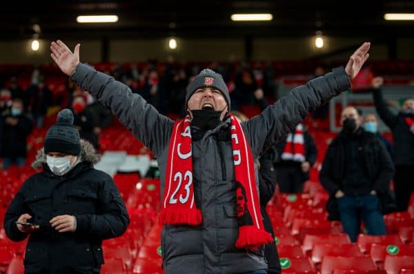 LIVERPOOL, ENGLAND - Sunday, December 6, 2020: A Liverpool supporter cheers on the players as they warm-up as the club welcomes 2,000 spectators back into the stadium, pictured before the FA Premier League match between Liverpool FC and Wolverhampton Wanderers FC at Anfield. (Pic by David Rawcliffe/Propaganda)