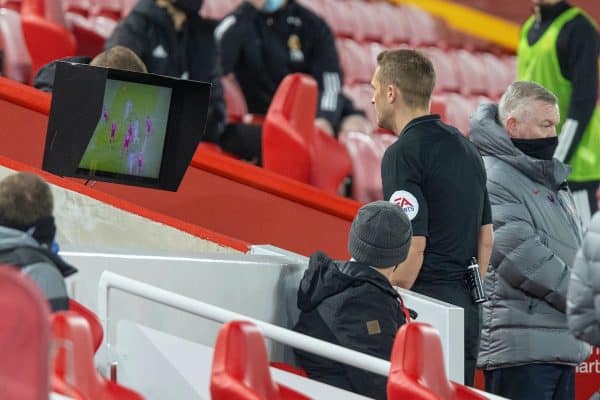 LIVERPOOL, ENGLAND - Sunday, December 6, 2020: Referee Craig Pawson looks at a replay on the VAR monitor and reverses his decision to award Wolverhampton Wanderers a penalty during the FA Premier League match between Liverpool FC and Wolverhampton Wanderers FC at Anfield. (Pic by David Rawcliffe/Propaganda)