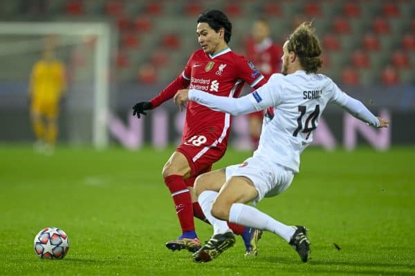 HERNING, DENMARK - Wednesday, December 9, 2020: Liverpool's Takumi Minamino (L) is challenged by FC Midtjylland's Alexander Scholz during the UEFA Champions League Group D match between FC Midtjylland and Liverpool FC at the Herning Arena. (Pic by Lars Møller/Propaganda)