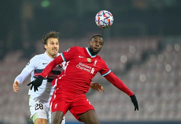 HERNING, DENMARK - Wednesday, December 9, 2020: Liverpool's Divock Origi (R) challenges for a header with FC Midtjylland's Erik Sviatchenko during the UEFA Champions League Group D match between FC Midtjylland and Liverpool FC at the Herning Arena. (Pic by Lars Møller/Propaganda)