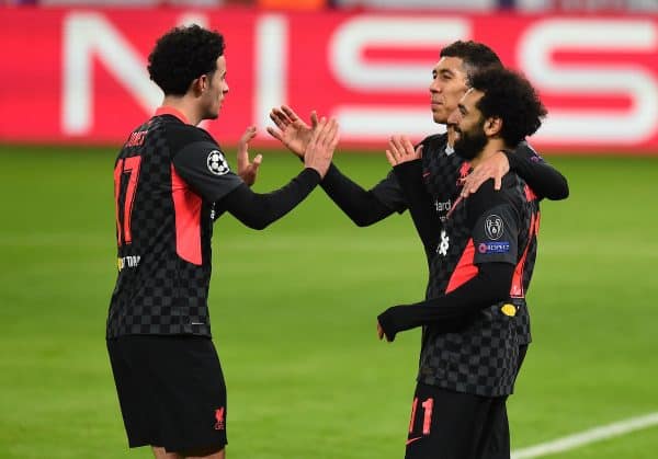 BUDAPEST, HUNGARY - Tuesday, February 16, 2021: Liverpool's Mohamed Salah (R) celebrates with team-mates Curtis Jones (L) and Roberto Firmino (C) after scoring the first goal during the UEFA Champions League Round of 16 1st Leg game between RB Leipzig and Liverpool FC at the Puskás Aréna. (Pic by Propaganda)