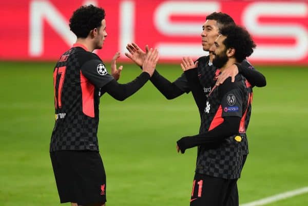 BUDAPEST, HUNGARY - Tuesday, February 16, 2021: Liverpool's Mohamed Salah (R) celebrates with team-mates Curtis Jones (L) and Roberto Firmino (C) after scoring the first goal during the UEFA Champions League Round of 16 1st Leg game between RB Leipzig and Liverpool FC at the Puskás Aréna. (Pic by Propaganda)