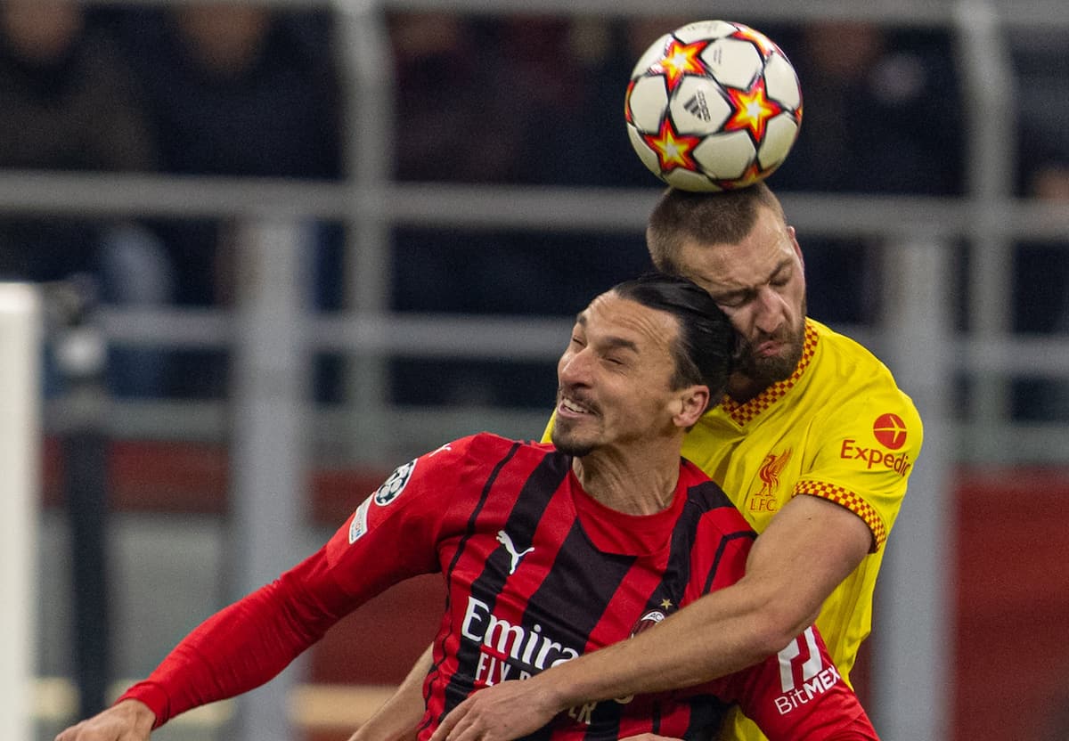 MILAN, ITALY - Tuesday, December 7, 2021: Liverpool's Nathaniel Phillips (R) challenges for a header with AC Milan's Zlatan Ibrahimovic? during the UEFA Champions League Group B Matchday 6 game between AC Milan and Liverpool FC at the Stadio San Siro. (Pic by David Rawcliffe/Propaganda)