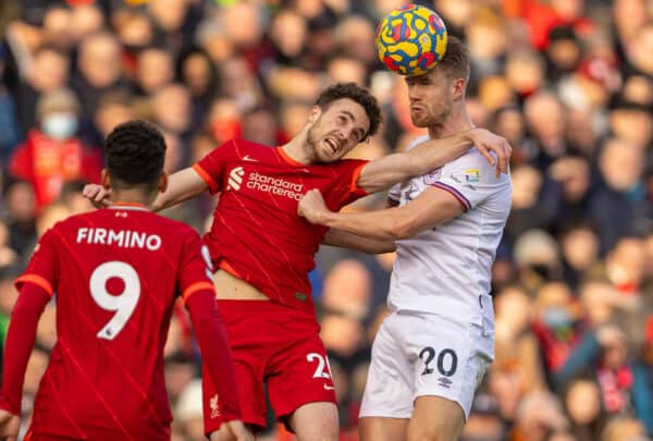 LIVERPOOL, ENGLAND - Sunday, January 16, 2022: Liverpool's Diogo Jota (L) challenges for a header with Brentford's Kristoffer Ajer during the FA Premier League match between Liverpool FC and Brentford FC at Anfield. (Pic by David Rawcliffe/Propaganda)