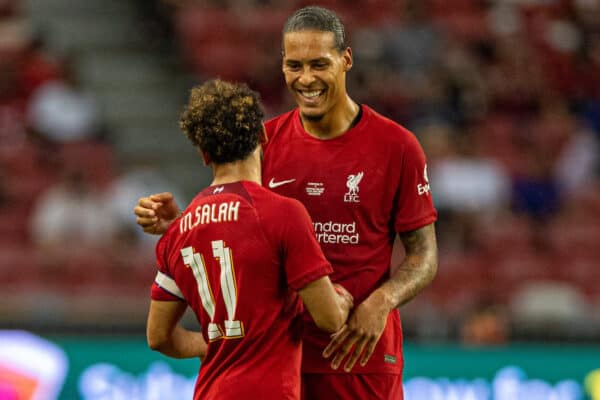 SINGAPORE - Friday, July 15, 2022: Liverpool's Virgil van Dijk hands the captain's armband to Mohamed Salah during the Standard Chartered Trophy pre-season friendly match between Liverpool FC and Crystal Palace FC at the Singapore National Stadium. (Pic by David Rawcliffe/Propaganda)