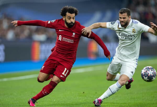 MADRID, SPAIN - Wednesday, March 15, 2023: Liverpool's Mohamed Salah (L) is challenged by Real Madrid's José Ignacio Fernández Iglesias 'Nacho' during the UEFA Champions League Round of 16 2nd Leg game between Real Madrid CF and Liverpool FC at the Estadio Santiago Bernabéu. (Pic by David Rawcliffe/Propaganda)