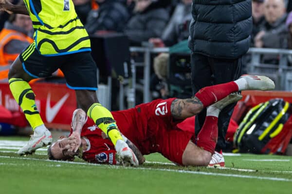 LIVERPOOL, ENGLAND - Saturday, December 23, 2023: Liverpool's Kostas Tsimikas crashes into manager Jürgen Klopp, and is then injured as the manager falls on him, during the FA Premier League match between Liverpool FC and Arsenal FC at Anfield. (Photo by David Rawcliffe/Propaganda)