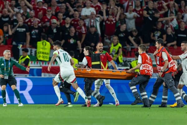 STUTTGART, GERMANY - Sunday, June 23, 2024: Hungary's captain Dominik Szoboszlai rushes to get a stretcher as the medical team stroll on the pitch slowly during the UEFA Euro 2024 Group A match between Scotland and Hungary at the Stuttgart Arena. (Photo by David Rawcliffe/Propaganda)