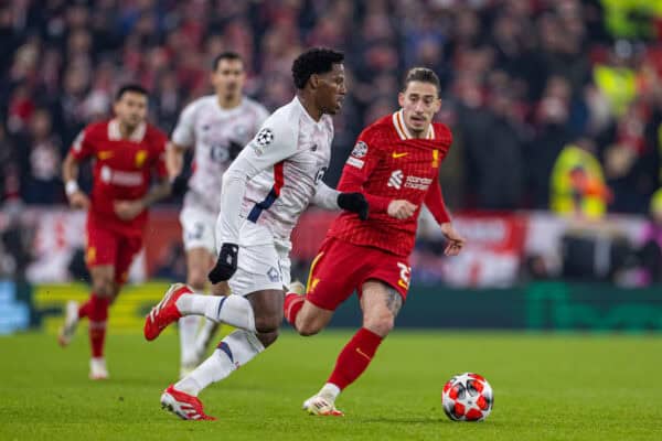 LIVERPOOL, ENGLAND - Tuesday, January 21, 2025: Liverpool's Kostas Tsimikas (R) closes down Lille's Jonathan David during the UEFA Champions League game between Liverpool FC and Lille OSC at Anfield. (Photo by David Rawcliffe/Propaganda)