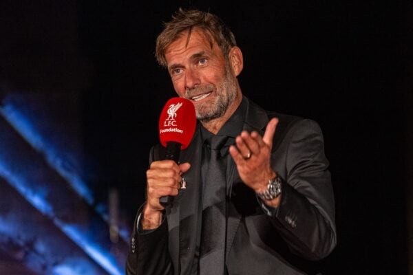 A man in a suit holding a microphone