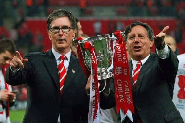 Liverpool's chairman Tom Werner, right, and owner John W. Henry, left, celebrate with the trophy after their team defeated Cardiff City, winning the English League Cup at the final soccer match at Wembley Stadium, in London, Sunday, Feb. 26, 2012. (AP Photo/Tim Hales)