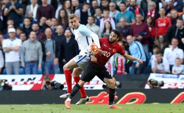 England's Jordan Henderson (left) and Turkey's Volkan Sen battle for the ball during the international friendly match at the Etihad Stadium, Manchester.