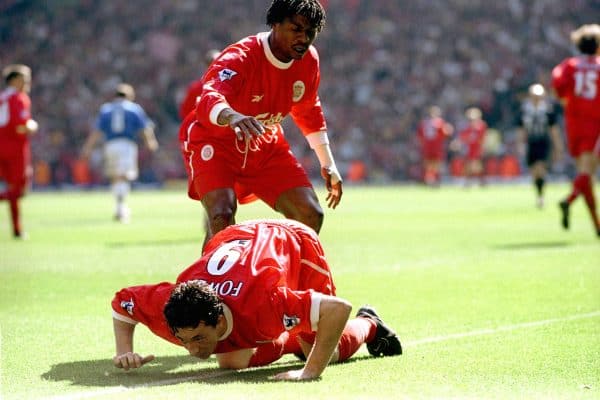 Liverpool's Rigobert Song (standing) congratulates Robbie Fowler after scoring their first goal as he pretends to snort cocaine from the touch line, after abuse from the Everton fans, 1999 (Neal Simpson/EMPICS Sport)