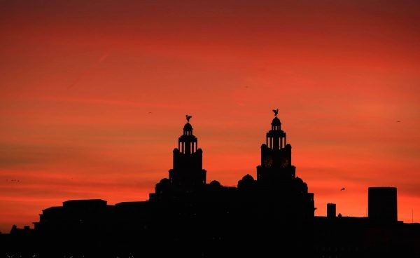 A view of the Royal Liver Building as the sun rises over Liverpool.