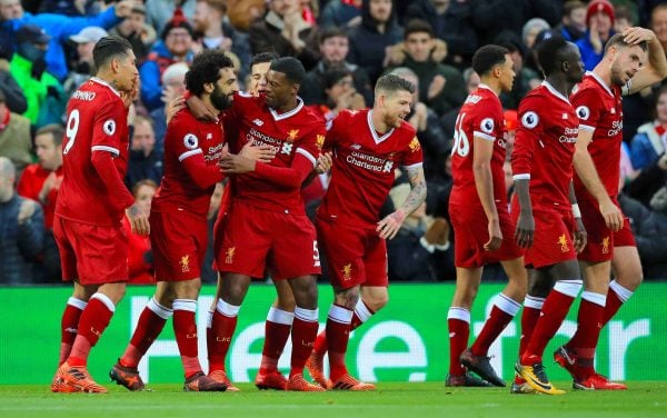 Liverpool's Mohamed Salah celebrates scoring his side's first goal of the game with team mates during the Premier League match at Anfield, Liverpool. (Peter Byrne/PA Wire.)