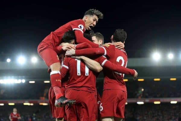 Liverpool's Mohamed Salah is mobbed by his team-mates as he celebrates scoring his side's second goal during the Premier League match at Anfield, Liverpool.