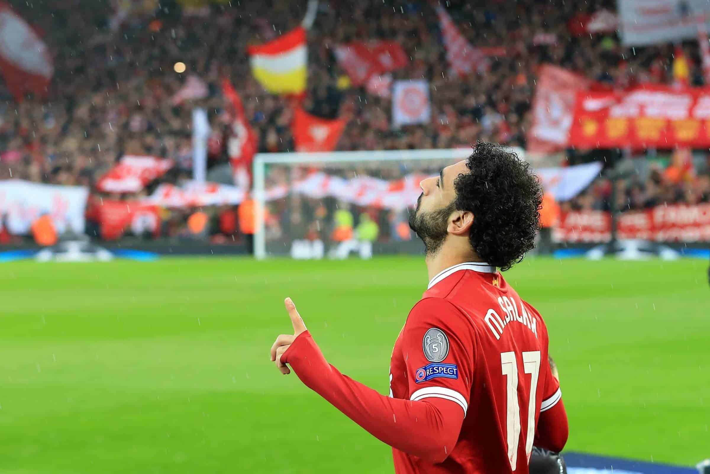 24th April 2018, Anfield, Liverpool, England; UEFA Champions League football, semi final, 1st leg, Liverpool versus AS Roma; Mohamed Salah of Liverpool says a prayer as he takes to the field in front of the Kop