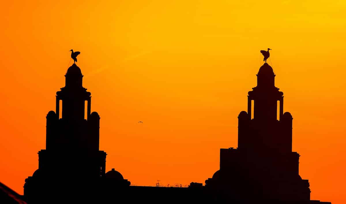 The sun sets behind the Royal Liverbuilding in Liverpool.