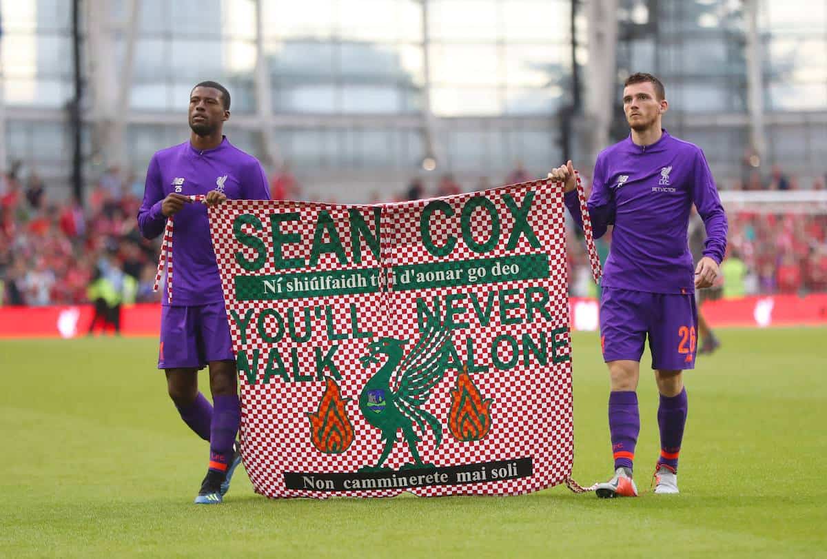 Liverpool's Georginio Wijnaldum (left) and Andy Robertson hold a banner for Liverpool fan Sean Cox after the pre-season friendly match at the Aviva Stadium (Niall Carson/PA Wire)