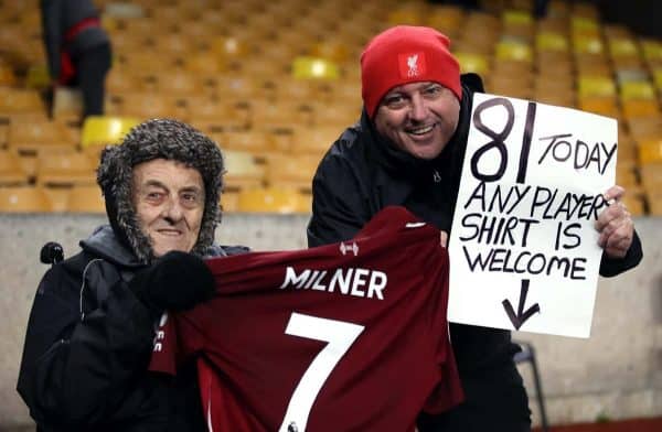 Liverpool fans pose with a shirt from James Milner after the Premier League match at Molineux, Wolverhampton (Nick Potts/PA Wire/PA Images)