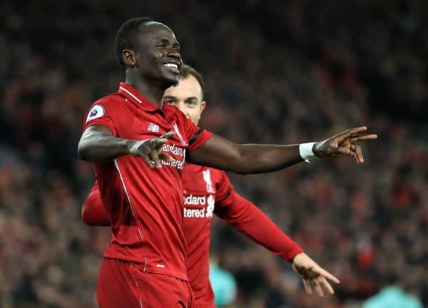 Liverpool's Sadio Mane (left) celebrates scoring his side's third goal of the game during the Premier League match at Anfield, Liverpool (Peter Byrne/PA Wire/PA Images)