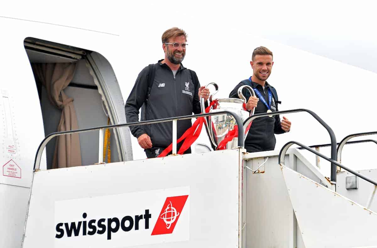 Liverpool manager Jurgen Klopp and Jordan Henderson with the trophy as they arrive back to John Lennon Airport, Liverpool. (PA Images)