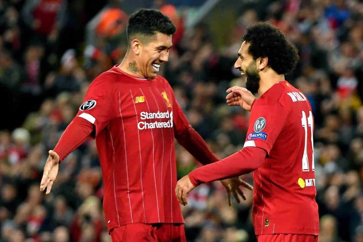 Liverpool's Mohamed Salah celebrates scoring his side's fourth goal of the game with teammate Roberto Firmino