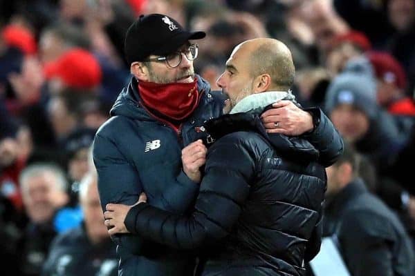 Liverpool manager Jurgen Klopp (left) and Manchester City manager Pep Guardiola hug after the final whistle during the Premier League match at Anfield, Liverpool.