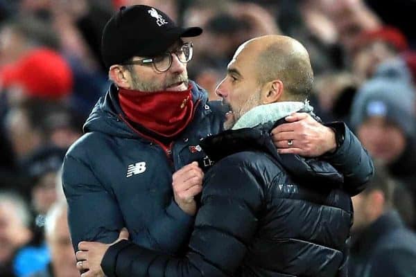 Liverpool manager Jurgen Klopp (left) and Manchester City manager Pep Guardiola hug after the final whistle during the Premier League match at Anfield, Liverpool.