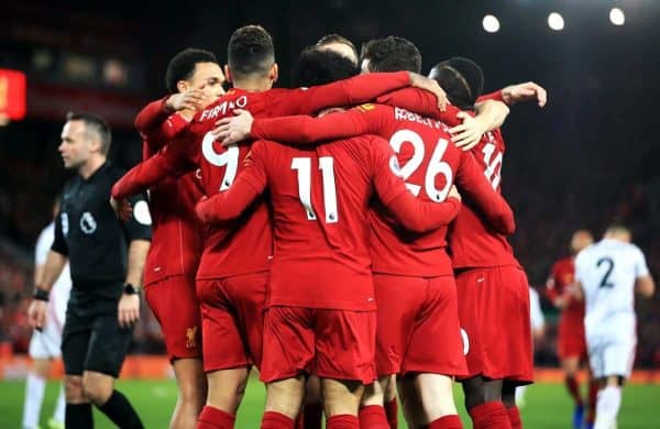 Liverpool's Mohamed Salah (centre) celebrates scoring his side's first goal of the game with team-mates during the Premier League match at Anfield, Liverpool.