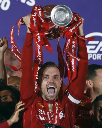 Liverpool players celebrate as Jordan Henderson lifts the Premier League trophy after the Premier League match at Anfield, Liverpool. (Phil Noble/PA Wire/PA Images)