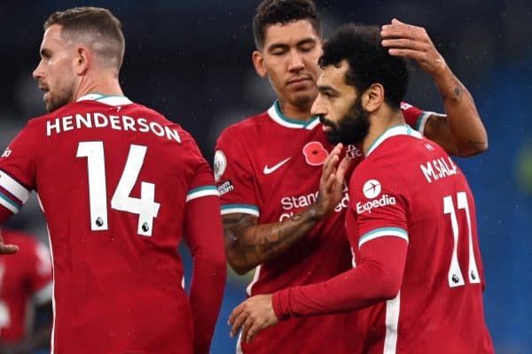 Liverpool's Mohamed Salah (right) celebrates scoring his side's first goal of the game from the penalty spot with Roberto Firmino during the Premier League match at the Etihad Stadium, Manchester.