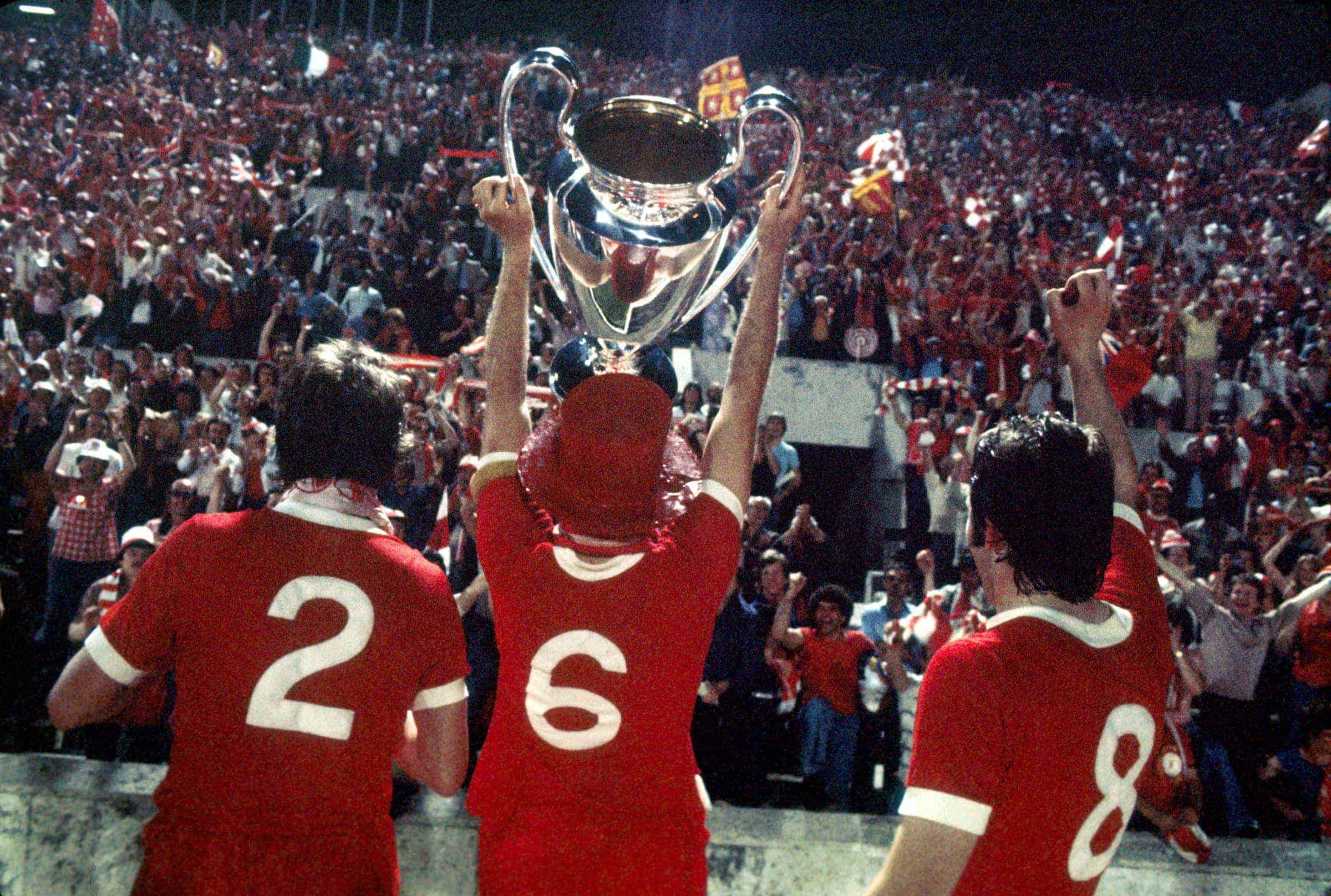 (L-R) Liverpool's Phil Neal, Emlyn Hughes and Jimmy Case show the European Cup to their jubilant fans