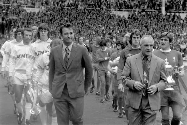 The two managers, Leeds United's Brian Clough and Liverpool's Bill Shankly, lead their teams out onto the pitch as the captains, Leeds United's Billy Bremner and Liverpool's Emlyn Hughes, carry the trophies their teams won the previous season. (l-r) Leeds United's Allan Clarke, Norman Hunter, Paul Reaney, Gordon McQueen, David Harvey, Billy Bremner, Brian Clough, Liverpool's Phil Thompson, Peter Cormack, Phil Boersma, Kevin Keegan, Alec Lindsay, Ray Clemence, Bill Shankly, Emlyn Hughes