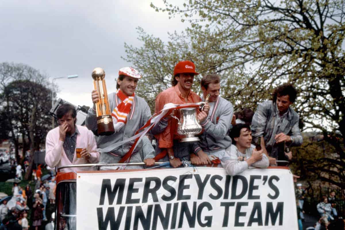 1986: Liverpool player-manager Kenny Dalglish (second l) shows off the League Championship trophy as teammate Mark Lawrenson (third l) displays the FA Cup during the team's celebratory open-topped bus journey through the city, the day after they completed the Double. The other players are Ronnie Whelan (l), Alan Hansen (second r) and Craig Johnston (r) ( PA Photos/PA Archive/PA Images)