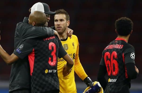 Liverpool's manager Jurgen Klopp, left, embraces his players Fabinho, left and goalkeeper Adrian, center as they celebrate their victory following the group D Champions League soccer match between Ajax and Liverpool at the Johan Cruyff ArenA in Amsterdam, Netherlands, Wednesday, Oct. 21, 2020. Liverpool won the match 1-0. (AP Photo/Peter Dejong)