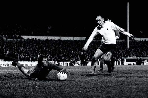 Ray Clemence dives at the feet of Tottenham’s Alan Gilzean (PA)