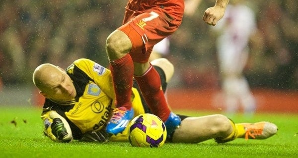 LIVERPOOL, ENGLAND - Saturday, January 18, 2014: Liverpool's Luis Suarez is brought down by Aston Villa's goalkeeper Brad Guzan for a penalty during the Premiership match at Anfield. (Pic by David Rawcliffe/Propaganda)