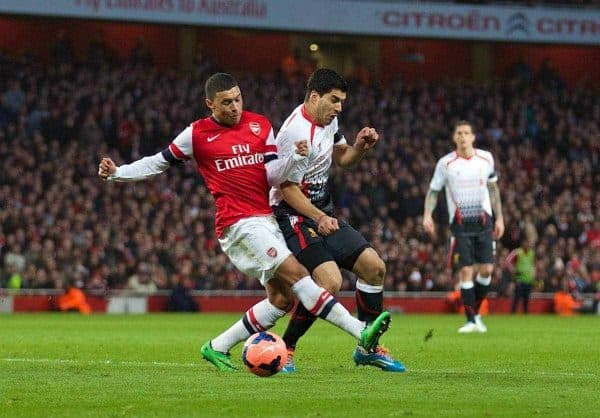 LONDON, ENGLAND - Sunday, February 16, 2014: Liverpool's Luis Suarez is hacked down by Arsenal's Alex Oxlade-Chamberlain but amazingly no penalty was given during the FA Cup 5th Round match at the Emirates Stadium. (Pic by David Rawcliffe/Propaganda)