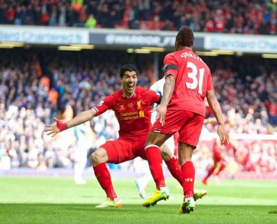 LIVERPOOL, ENGLAND - Sunday, April 13, 2014: Liverpool's Raheem Sterling celebrates scoring the first goal against Manchester City with team-mate Luis Suarez during the Premiership match at Anfield. (Pic by David Rawcliffe/Propaganda)