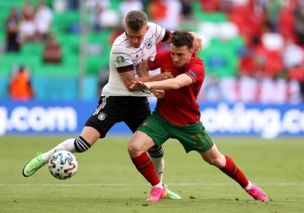 MUNICH, GERMANY - JUNE 19: Diogo Jota of Portugal holds off Matthias Ginter of Germany during the UEFA Euro 2020 Championship Group F match between Portugal and Germany at Football Arena Munich on June 19, 2021 in Munich, Germany. (Photo by Alex Grimm - UEFA/UEFA via Getty Images)