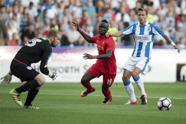 HUDDERSFIELD, ENGLAND - Wednesday, July 19, 2016: Liverpool's Sadio Mane in action against Huddersfield Town's Chris Lowe during the pre-season friendly match at the John Smith’s Stadium. (Pic by Paul Greenwood/Propaganda)