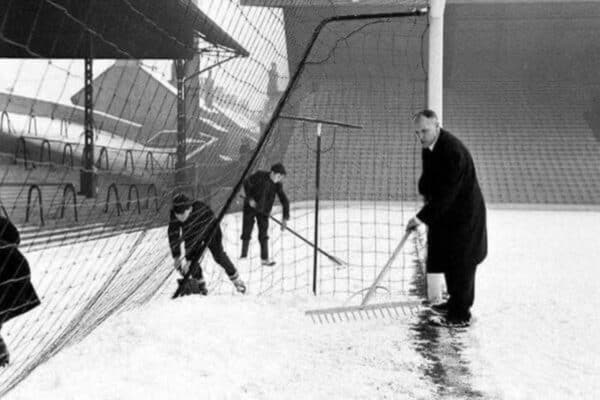 Roy Lindo seen her at the back of the goal, assisting Shankly as they clear the Anfield pitch of snow. Decemer 1964